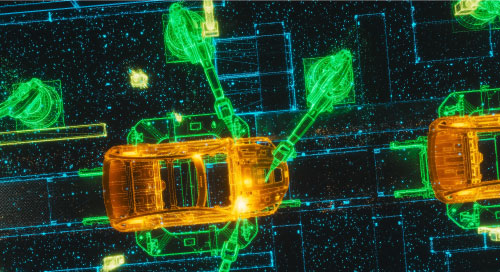 Looking down on an assembly line with robots working on automobiles.