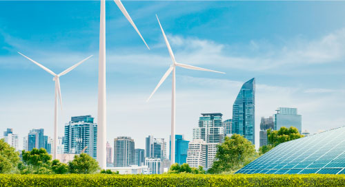 Wind turbines and solar panels in a field with a futuristic city skyline in the background.